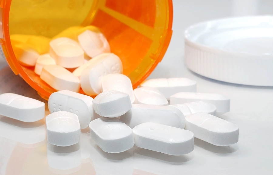 White pills spilling out of bottle